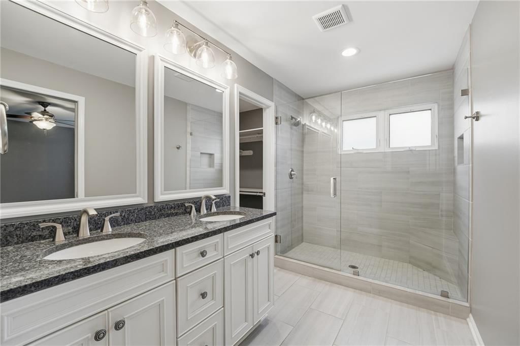 Walk-in shower, tiled shower and double vanity at 15762 Horton Street, Overland Park, KS 66223