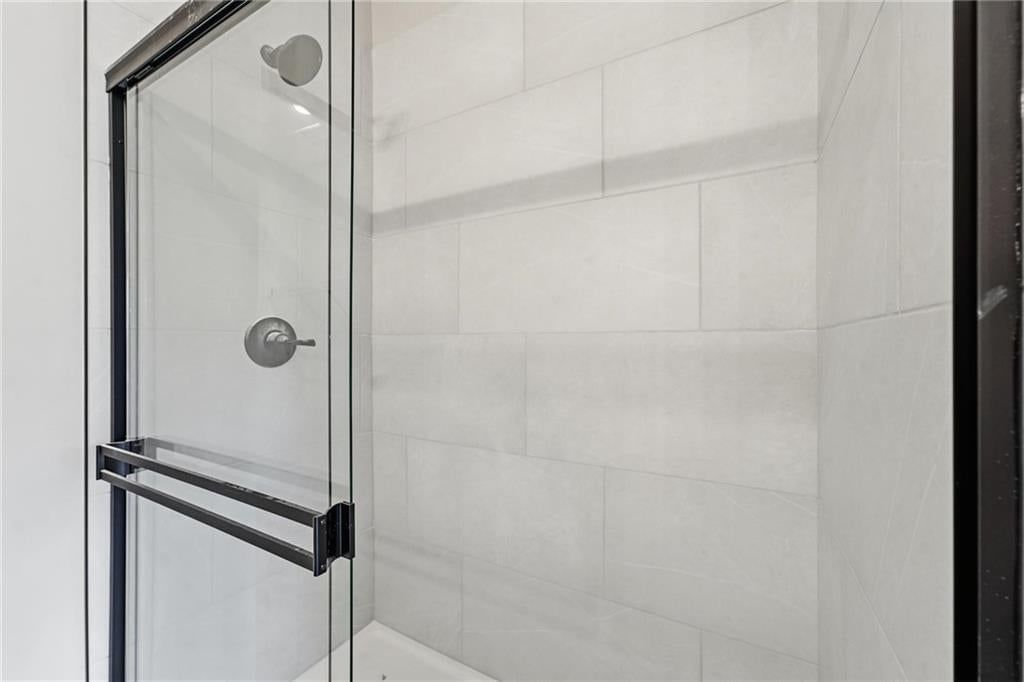 Walk-in shower and tiled shower at 1600 SW 10th Terrace, Oak Grove, MO 64075