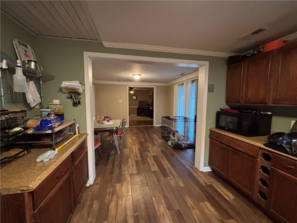 Open floor plan, breakfast nook and wood kitchen cabinets at 320 Martin Avenue, Osawatomie, KS 66064