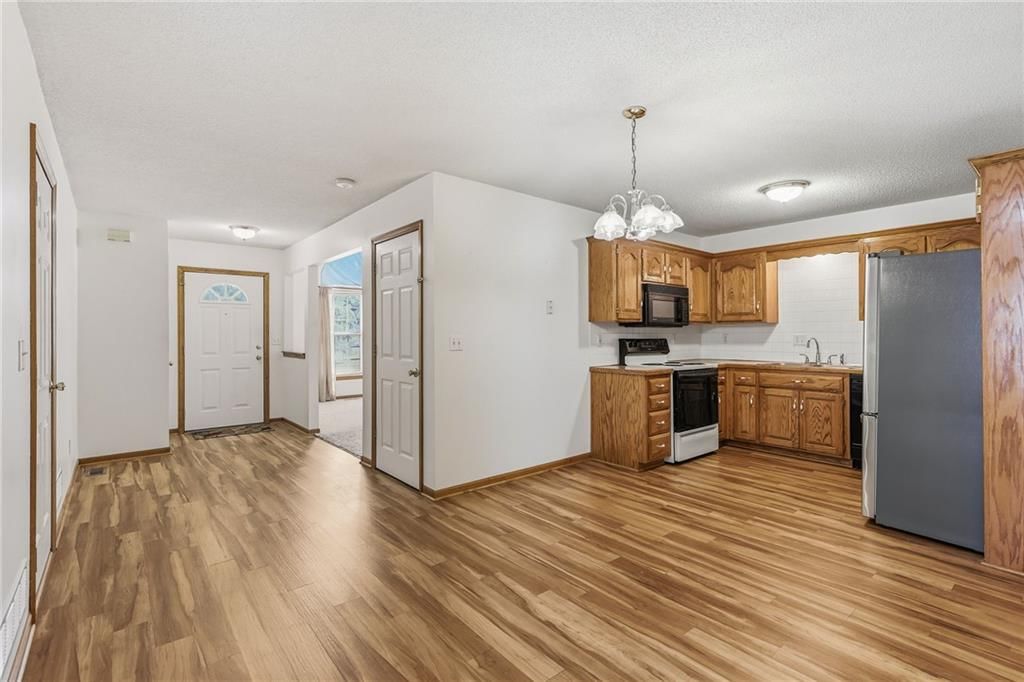 Open floor plan, stainless steel appliances and breakfast nook at 10504-06 Maple Avenue, Peculiar, MO 64078