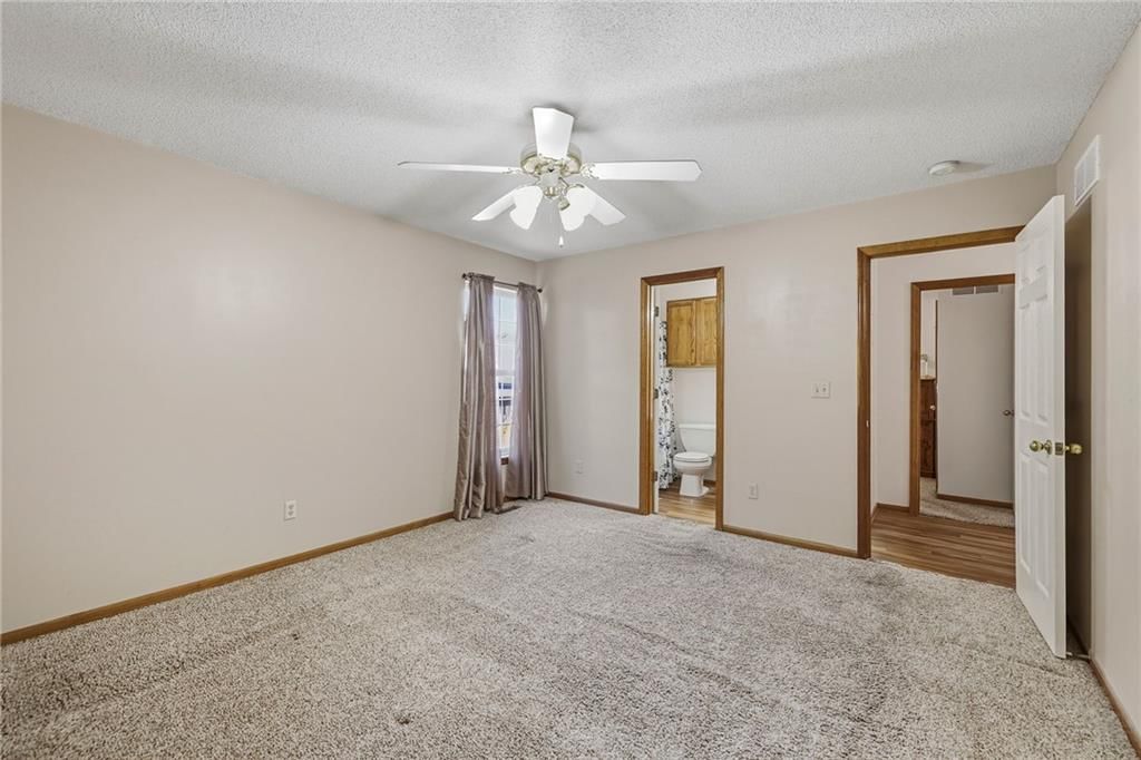 Main-floor primary bedroom at 10504-06 Maple Avenue, Peculiar, MO 64078