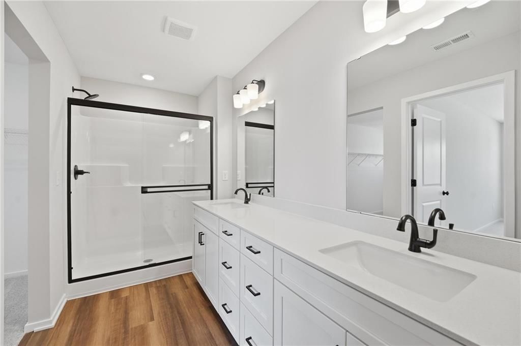 Walk-in shower and double vanity at 1601 SW 10th Terrace, Oak Grove, MO 64075