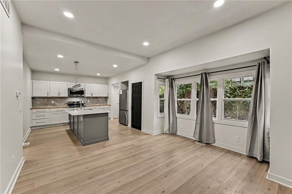 Open floor plan, kitchen island and hardwood floors at 1511 N 28Th Street, Kansas City, KS 66102