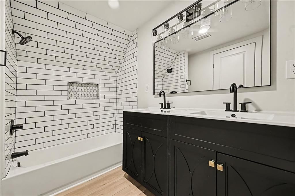 Tiled shower, double vanity and black vanity at 1511 N 28Th Street, Kansas City, KS 66102