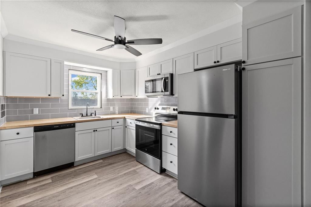 Butcher block countertops, gray kitchen cabinets and shaker cabinets at 4311 Yecker Avenue, Kansas City, KS 66104