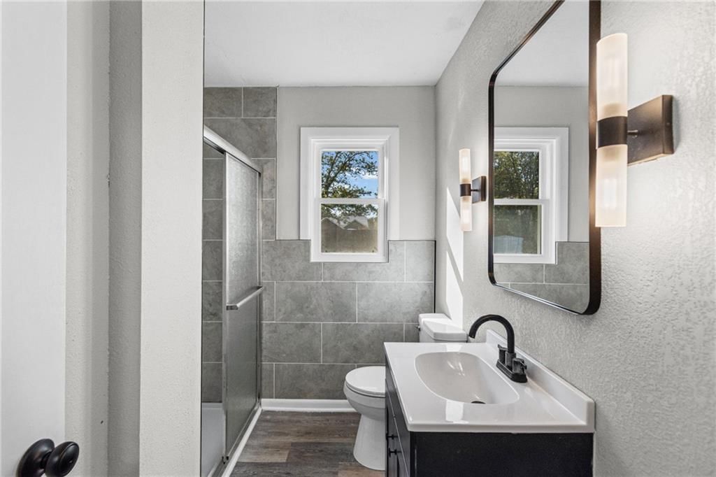 Tiled shower and renovated bathrooms at 4311 Yecker Avenue, Kansas City, KS 66104