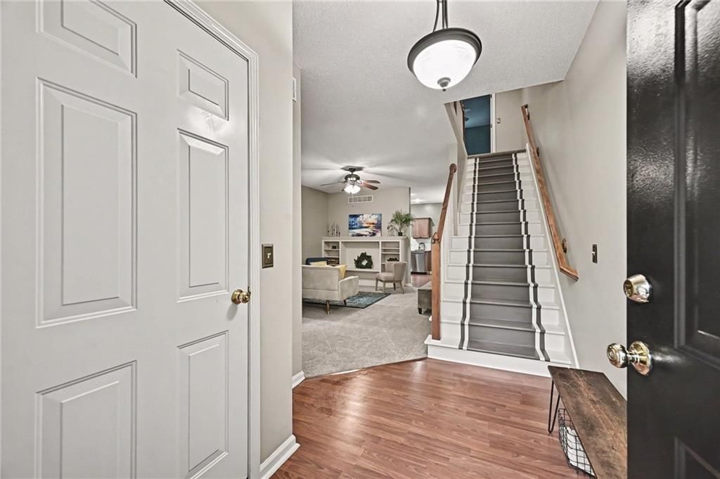 Staircase, wood stair railing and white trim at 7313 McCoy Street, Shawnee, KS 66227