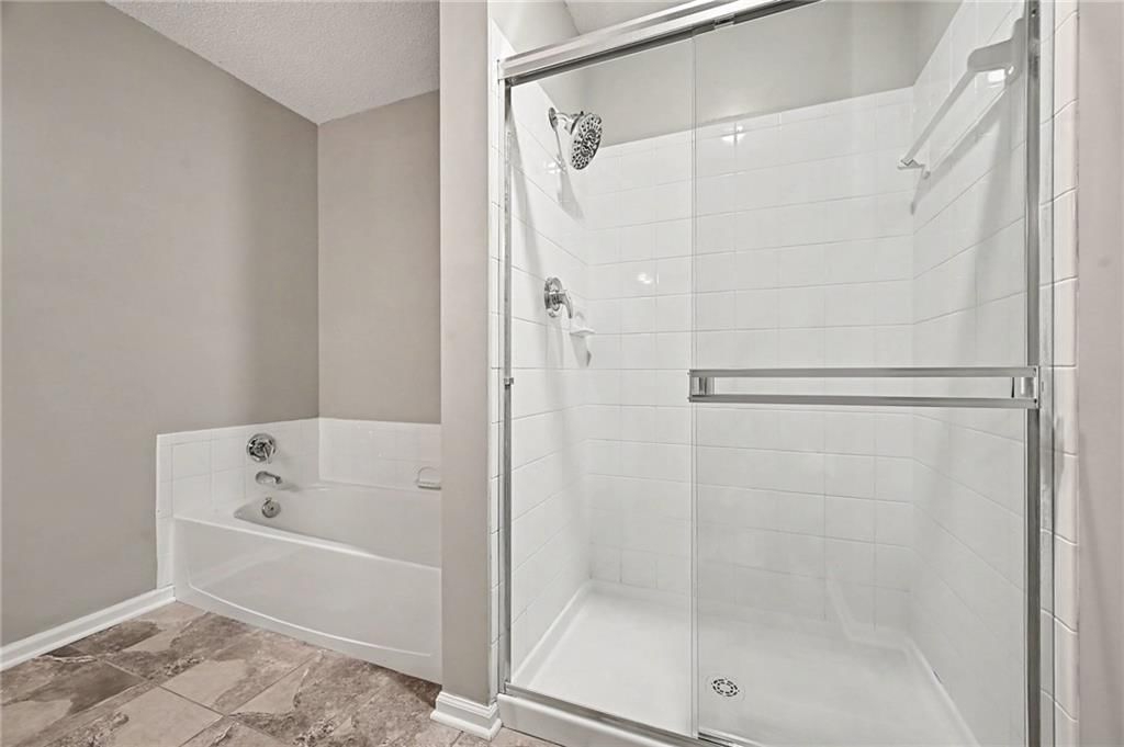 Walk-in shower and tiled shower at 7313 McCoy Street, Shawnee, KS 66227