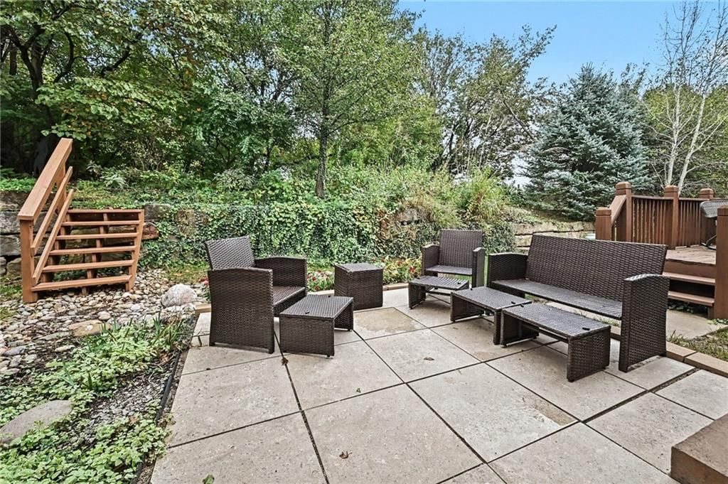 Deck, mature trees and flat lot at 7313 McCoy Street, Shawnee, KS 66227