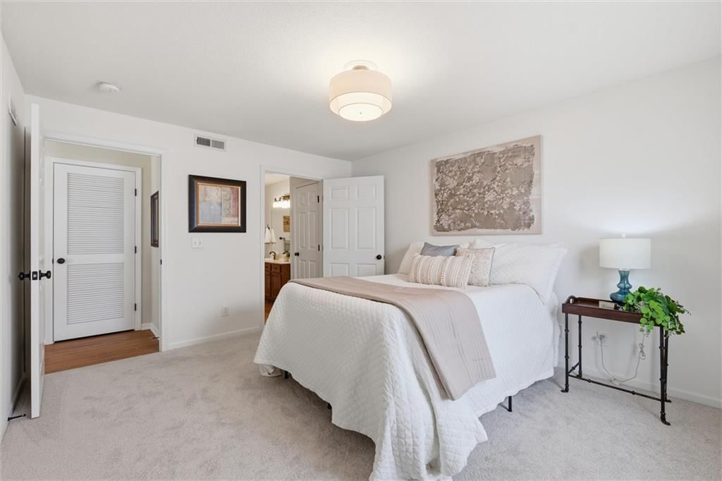 Main-floor primary bedroom and carpet at 5610 NE 80th Terrace #2B, Kansas City, MO 64119