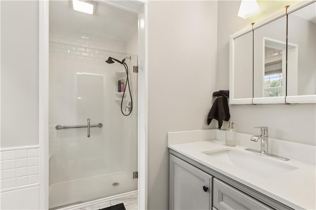 Walk-in shower, tiled shower and frameless glass shower at 4107 E 107th Terrace, Kansas City, MO 64137