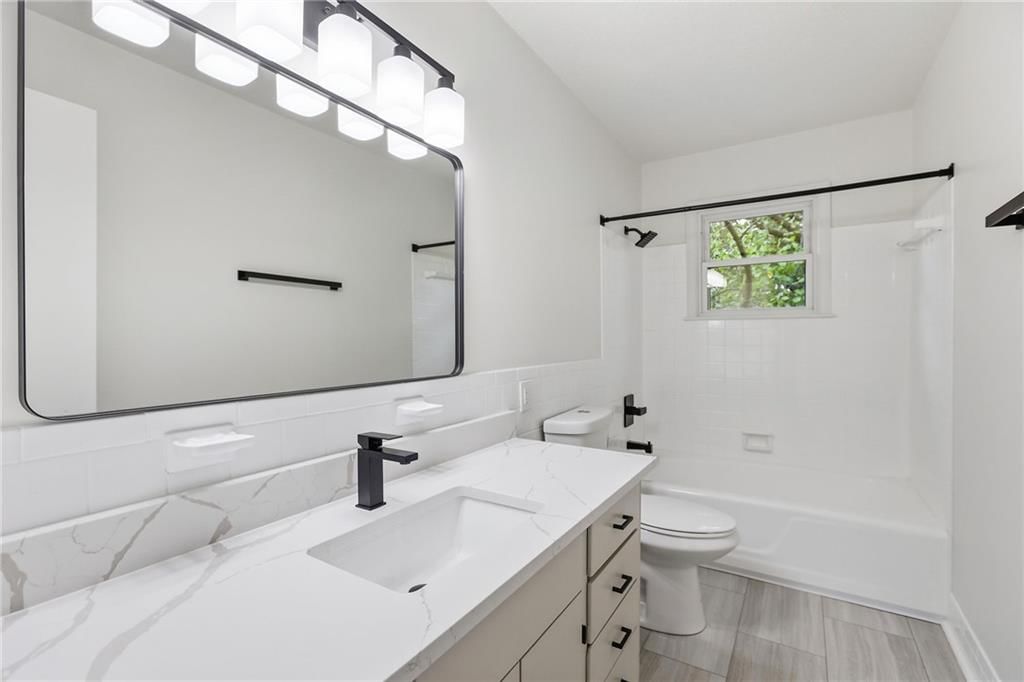 Renovated bathrooms and black hardware at 5008 Spring Street, Kansas City, MO 64133