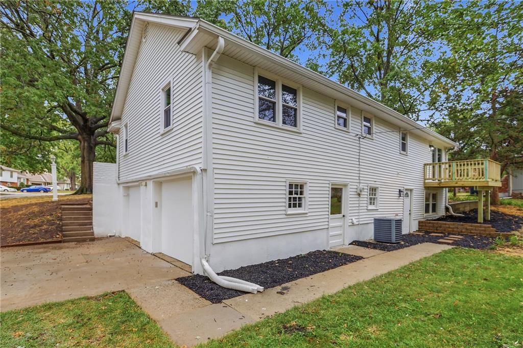 Attached garage and concrete driveway at 5008 Spring Street, Kansas City, MO 64133