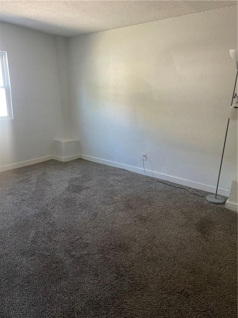 Main-floor primary bedroom and carpet at 2107 E 77th Terrace, Kansas City, MO 64132
