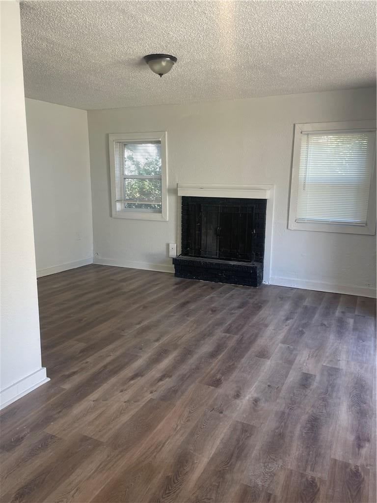 Fireplace, open floor plan and luxury vinyl floors at 2107 E 77th Terrace, Kansas City, MO 64132