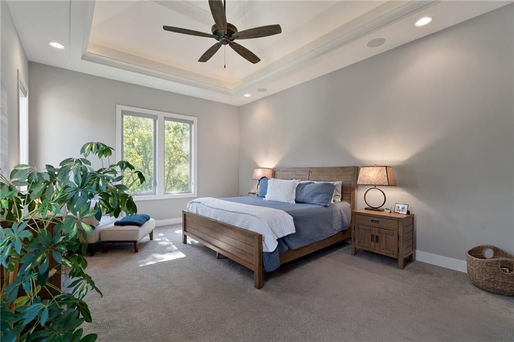 Main-floor primary bedroom, tray ceiling and carpet at 2181 W 89th Place, Leawood, KS 66206