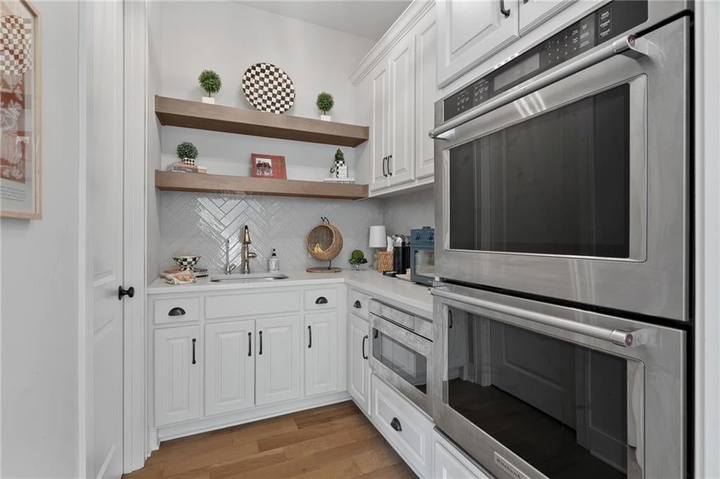 Butler's pantry, double oven and black hardware at 2181 W 89th Place, Leawood, KS 66206