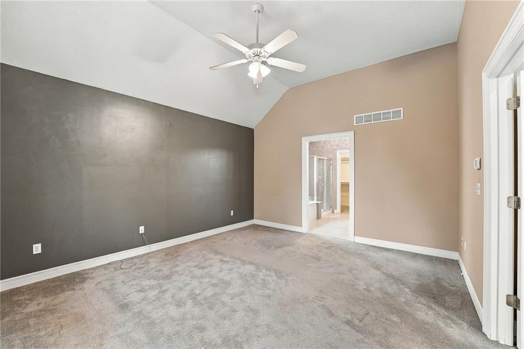 Main-floor primary bedroom and accent wall at 13408 Summit Court, Kansas City, MO 64145