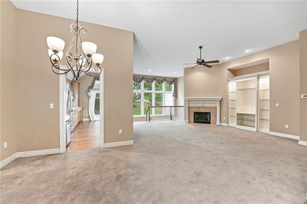 Fireplace and wall of windows at 13408 Summit Court, Kansas City, MO 64145