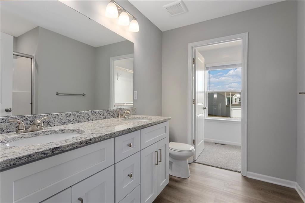 Double vanity, white vanity and chrome hardware at 510 Foxglove Lane, Raymore, MO 64083