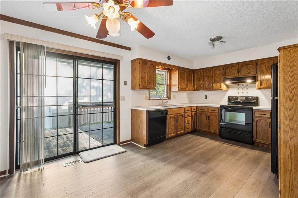 Breakfast nook, wood kitchen cabinets and electric range at 6906 N CHAS Drive, Pleasant Valley, MO 64068