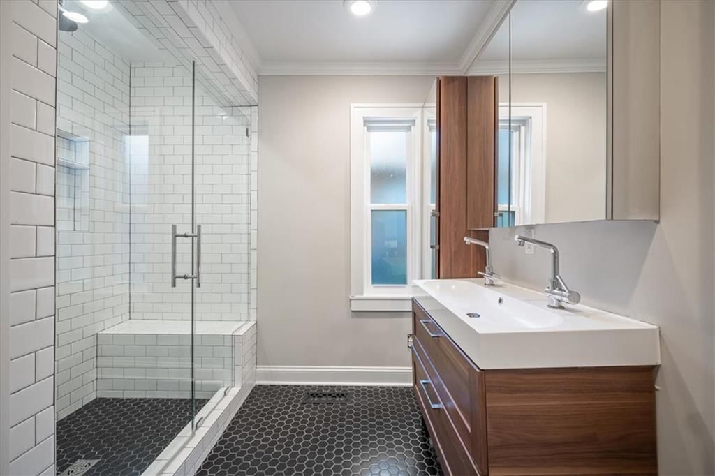 Walk-in shower, tiled shower and double vanity at 211 E 66TH Street, Kansas City, MO 64113