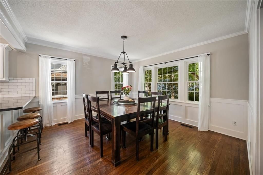 Open floor plan, statement lighting and wainscoting or board and batten at 211 E 66TH Street, Kansas City, MO 64113