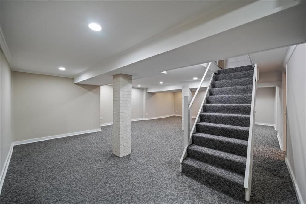 Finished basement, staircase and wood stair railing at 211 E 66TH Street, Kansas City, MO 64113