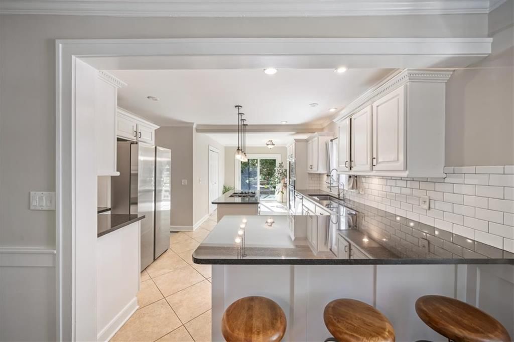 Kitchen island, white kitchen and shaker cabinets at 211 E 66TH Street, Kansas City, MO 64113