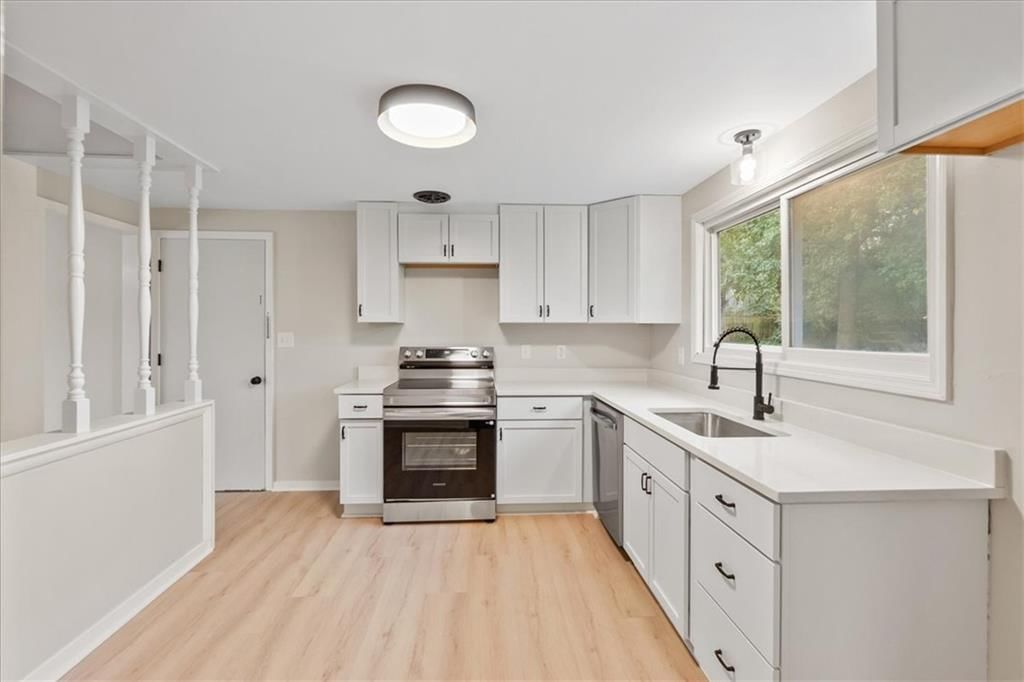 White kitchen, shaker cabinets and stainless steel appliances at 5400 Outlook Street, Mission, KS 66202