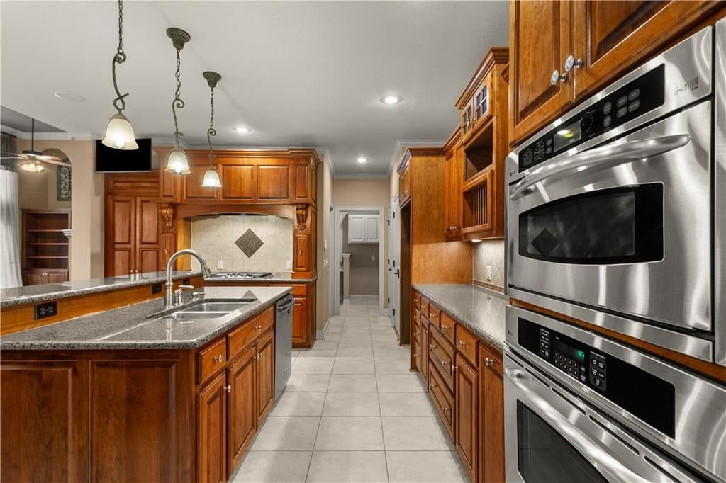 Kitchen island, walk-in pantry and double oven at 205 SW LEWIS Court, Lee's Summit, MO 64081