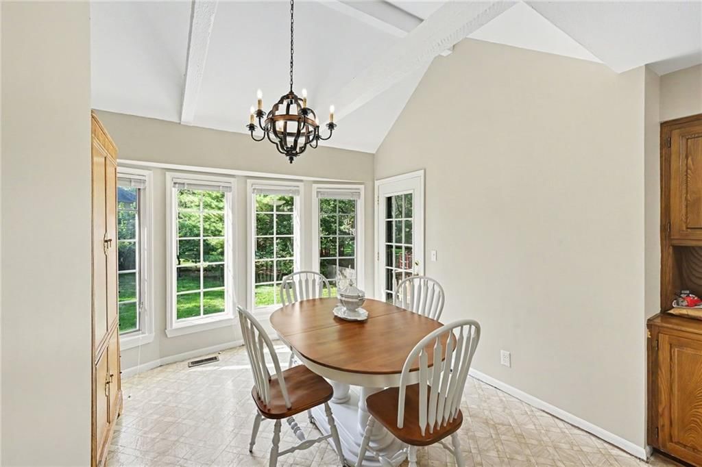 Chandelier, wall of windows and breakfast nook at 2305 W 120th Terrace, Leawood, KS 66209