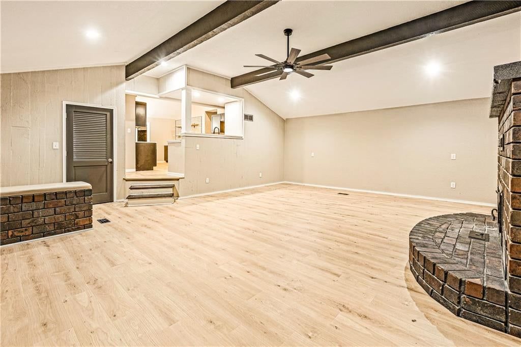Fireplace, engineered wood floors and exposed brick wall at 2712 S Sante Fe Road, Independence, MO 64052