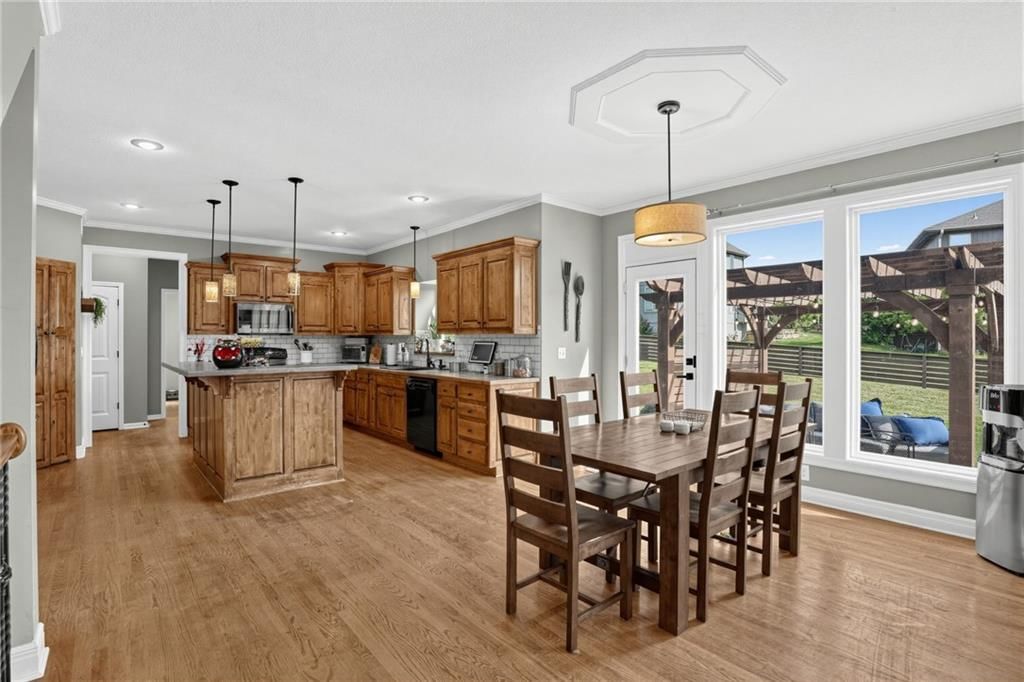 Kitchen island, wood kitchen cabinets and kitchen backsplash at 5023 Haskins Street, Shawnee, KS 66216