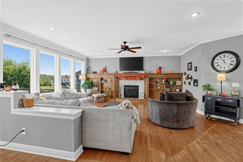 Fireplace, open floor plan and wall of windows at 5023 Haskins Street, Shawnee, KS 66216