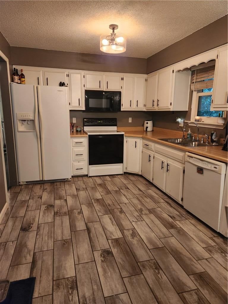 White kitchen, white appliances and electric range at 10506 N Baltimore Avenue, Kansas City, MO 64155