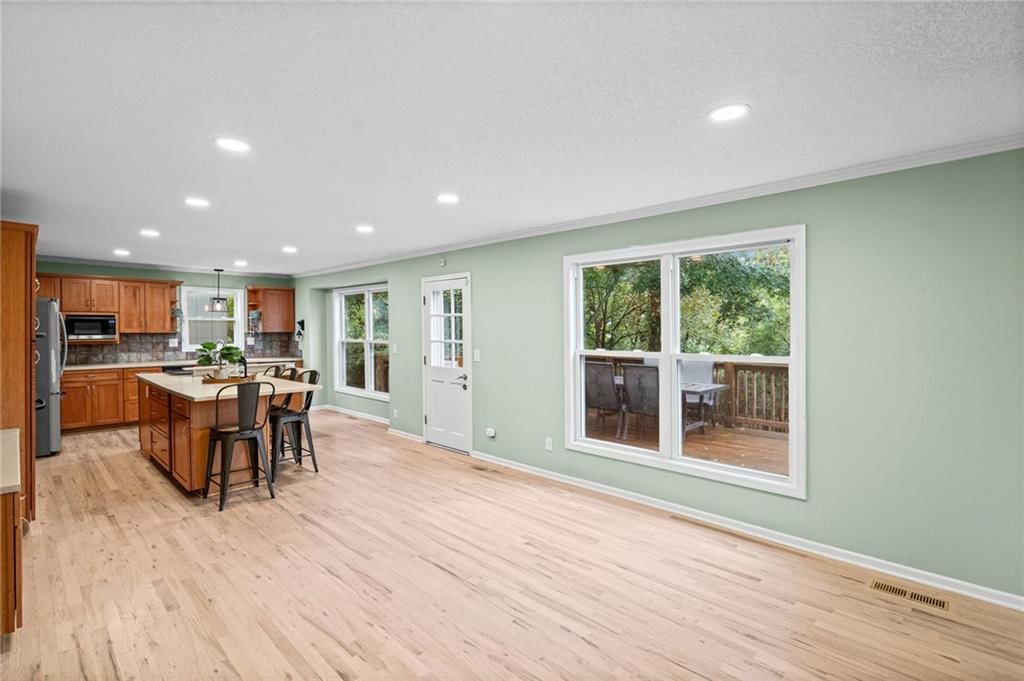 Open floor plan, kitchen island and double oven at 10324 Rosehill Road, Overland Park, KS 66215