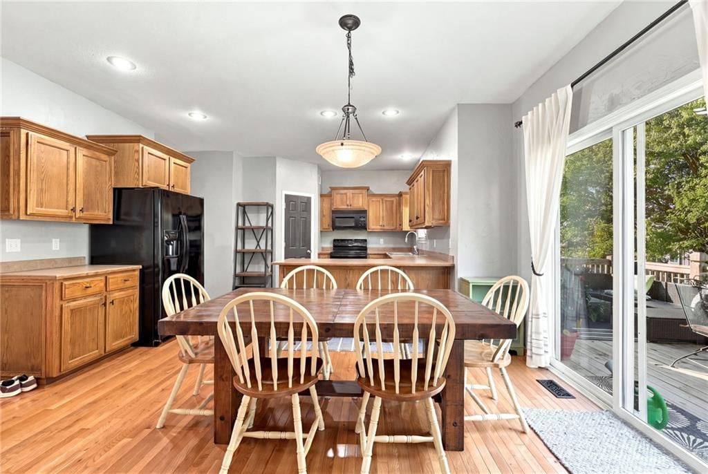 Open floor plan, kitchen island and hardwood floors at 372 W Madison Street, Gardner, KS 66030