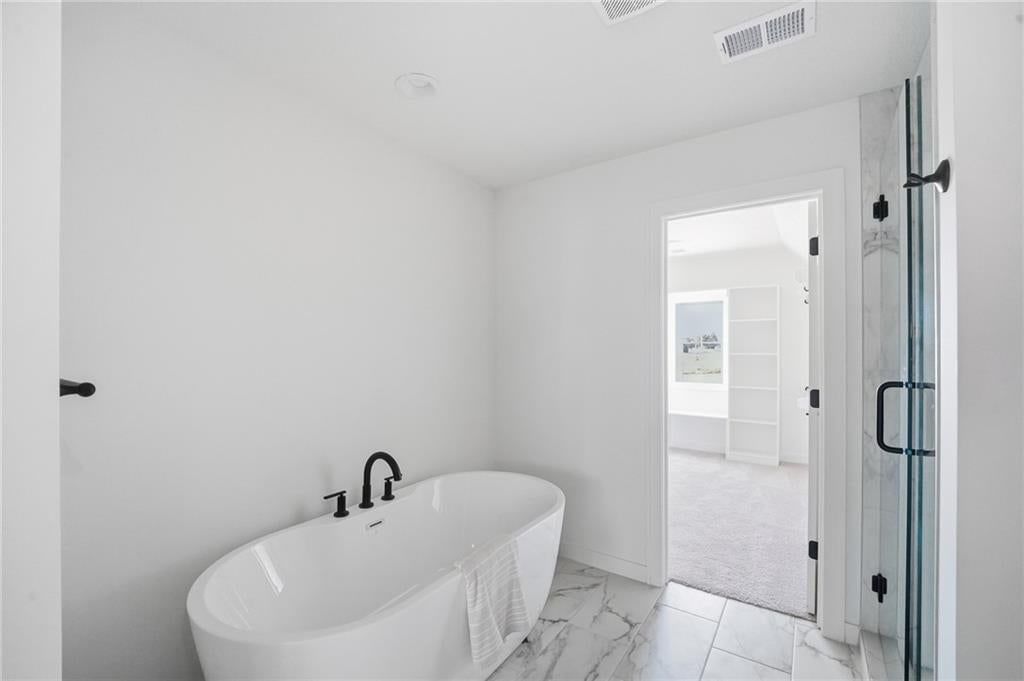 Walk-in shower, freestanding tub and tiled shower at 18330 W 195th Street, Spring Hill, KS 66083