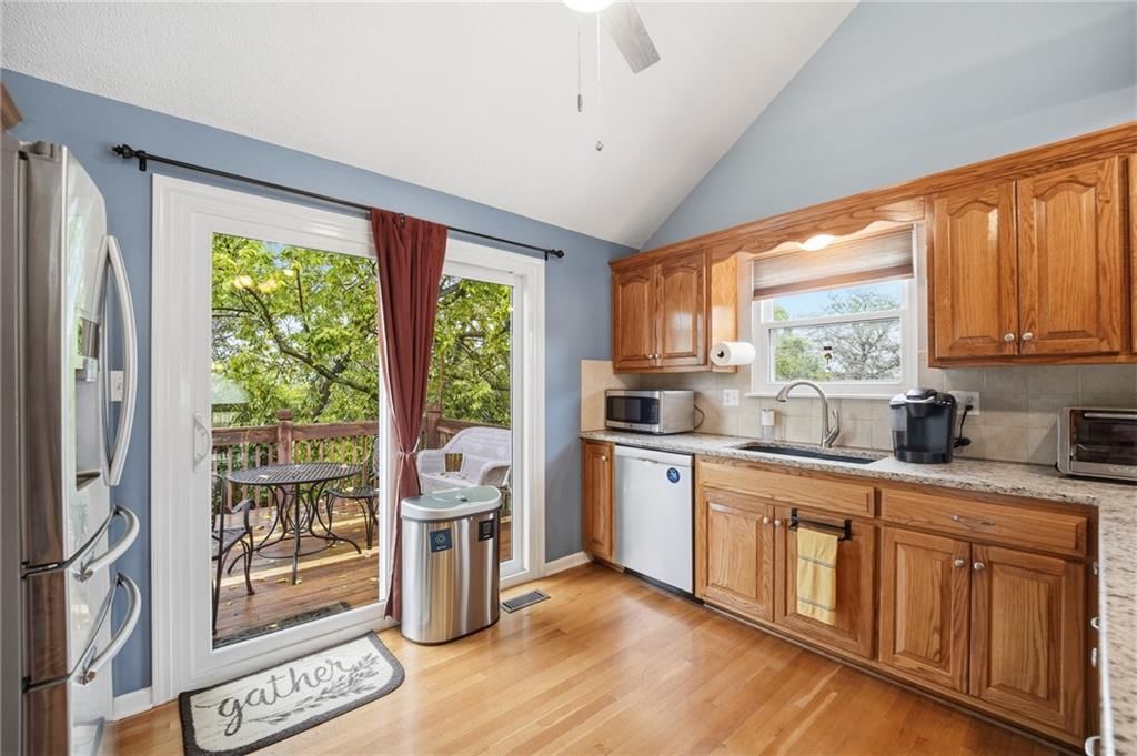 Mature trees, granite counters and kitchen backsplash at 2252 SW Morris Drive, Lee's Summit, MO 64082