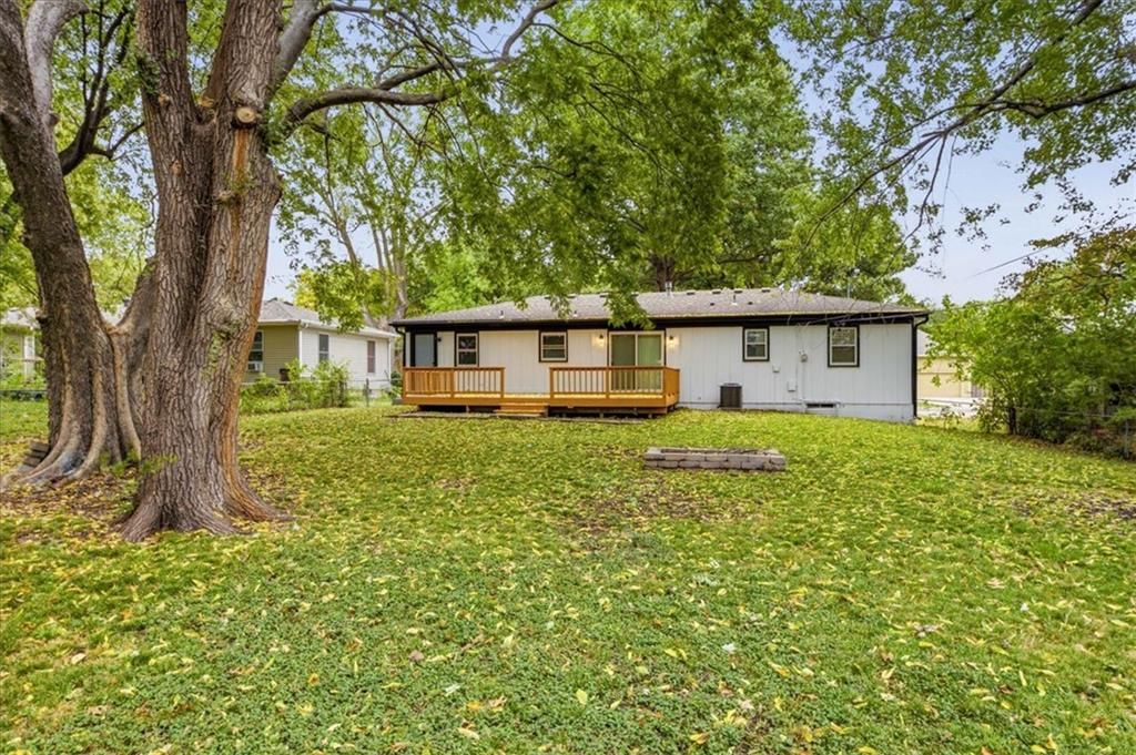 Deck, big backyard and mature trees at 8520 Larsen Street, Overland Park, KS 66214
