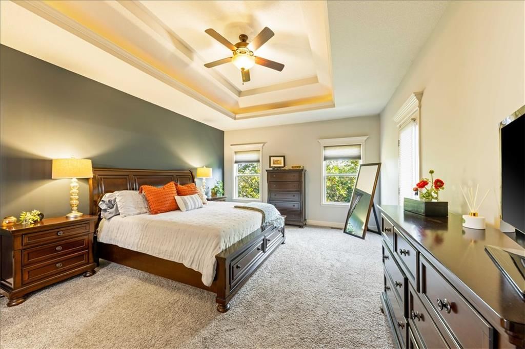 Main-floor primary bedroom, tray ceiling and black hardware at 15096 NW 66th Street, Parkville, MO 64152