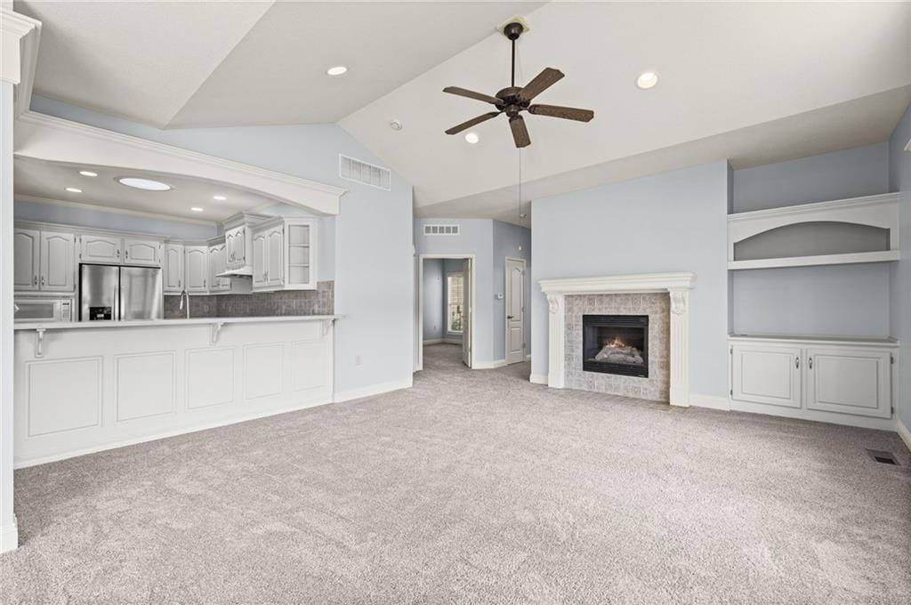 Fireplace, open floor plan and wall of windows at 14561 Birch Street #22, Leawood, KS 66224