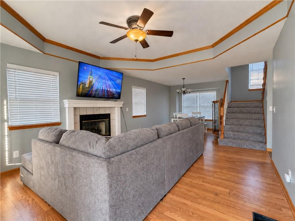 Fireplace, open floor plan and tray ceiling at 1001 Peggy Drive, Greenwood, MO 64034