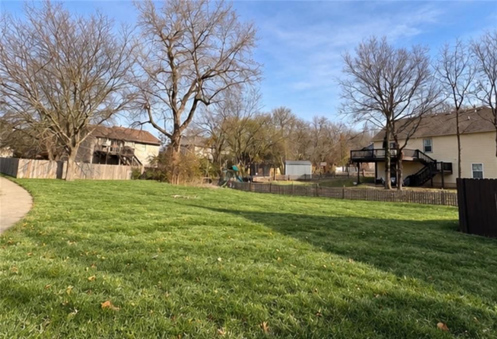 Big backyard, fenced yard and mature trees at 1001 Peggy Drive, Greenwood, MO 64034