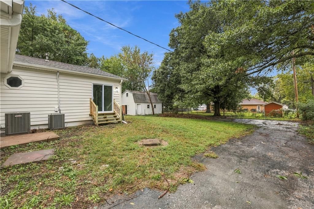 Big backyard, mature trees and flat lot at 702 SW Locust Street, Oak Grove, MO 64075
