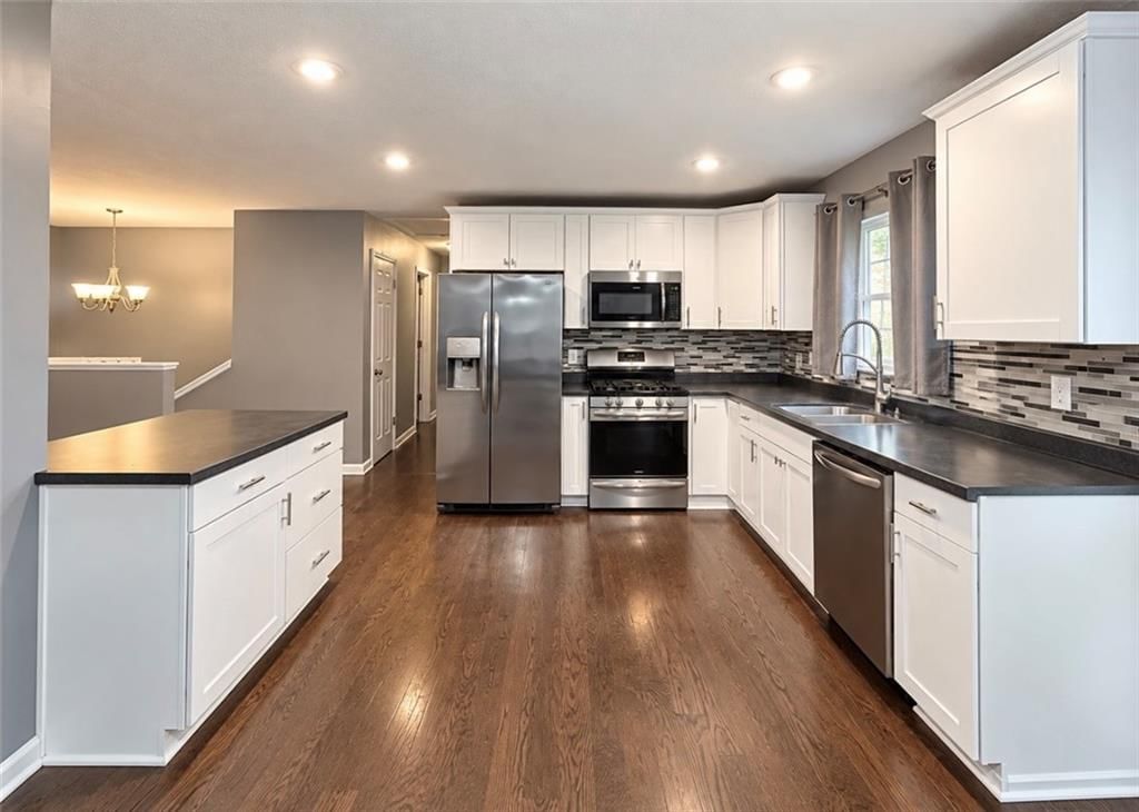 White kitchen, shaker cabinets and stainless steel appliances at 12807 E 39th Terrace S, Independence, MO 64055