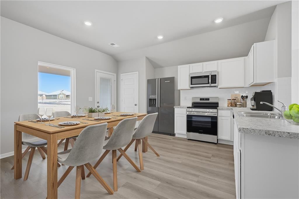White kitchen, breakfast nook and kitchen backsplash at 20373 W 195th Street, Spring Hill, KS 66083