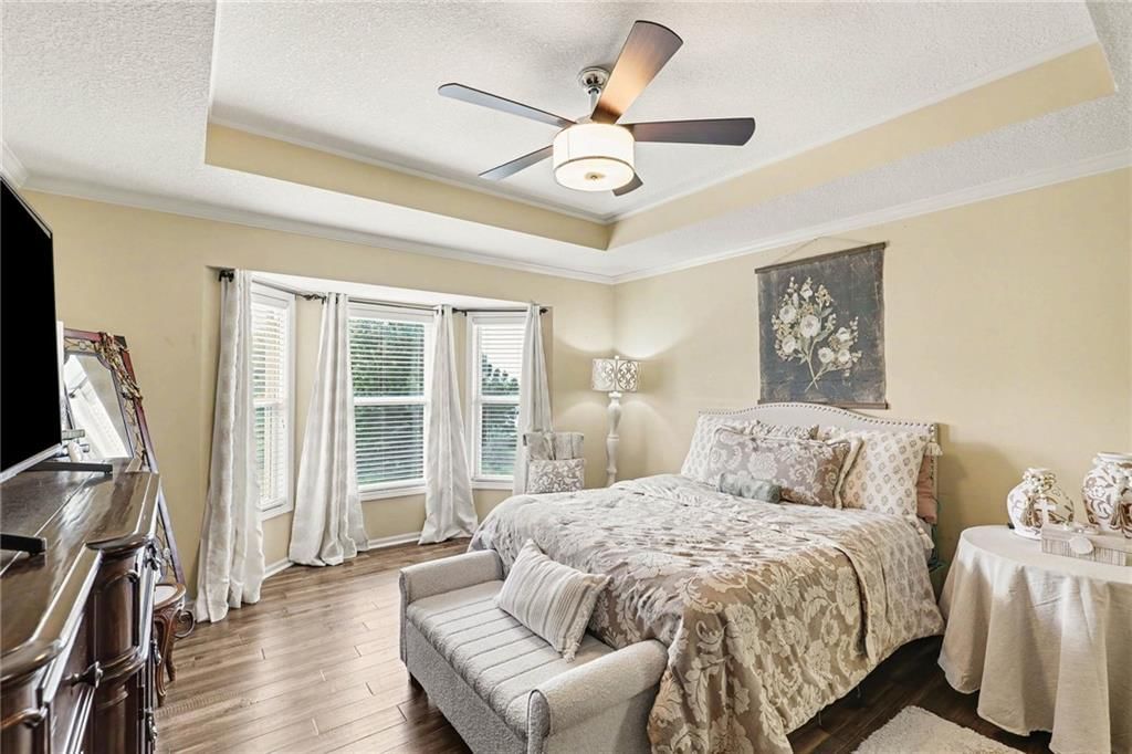 Main-floor primary bedroom and tray ceiling at 3213 Devonshire Drive, Platte City, MO 64079