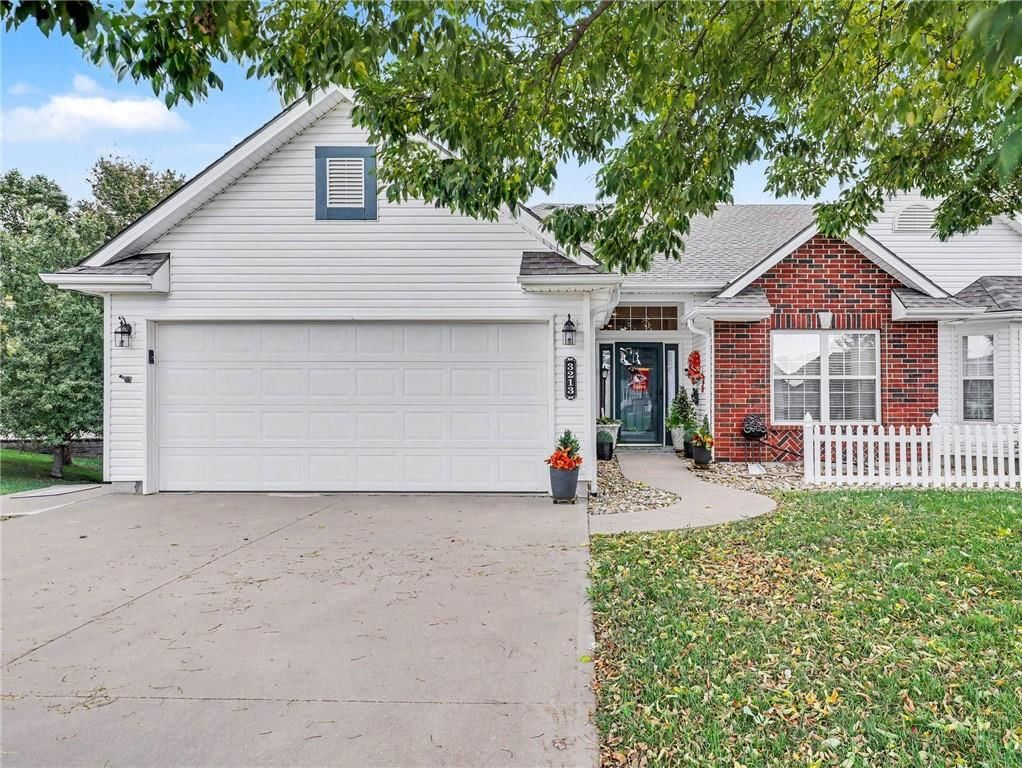 Covered front porch, attached garage and concrete driveway at 3213 Devonshire Drive, Platte City, MO 64079